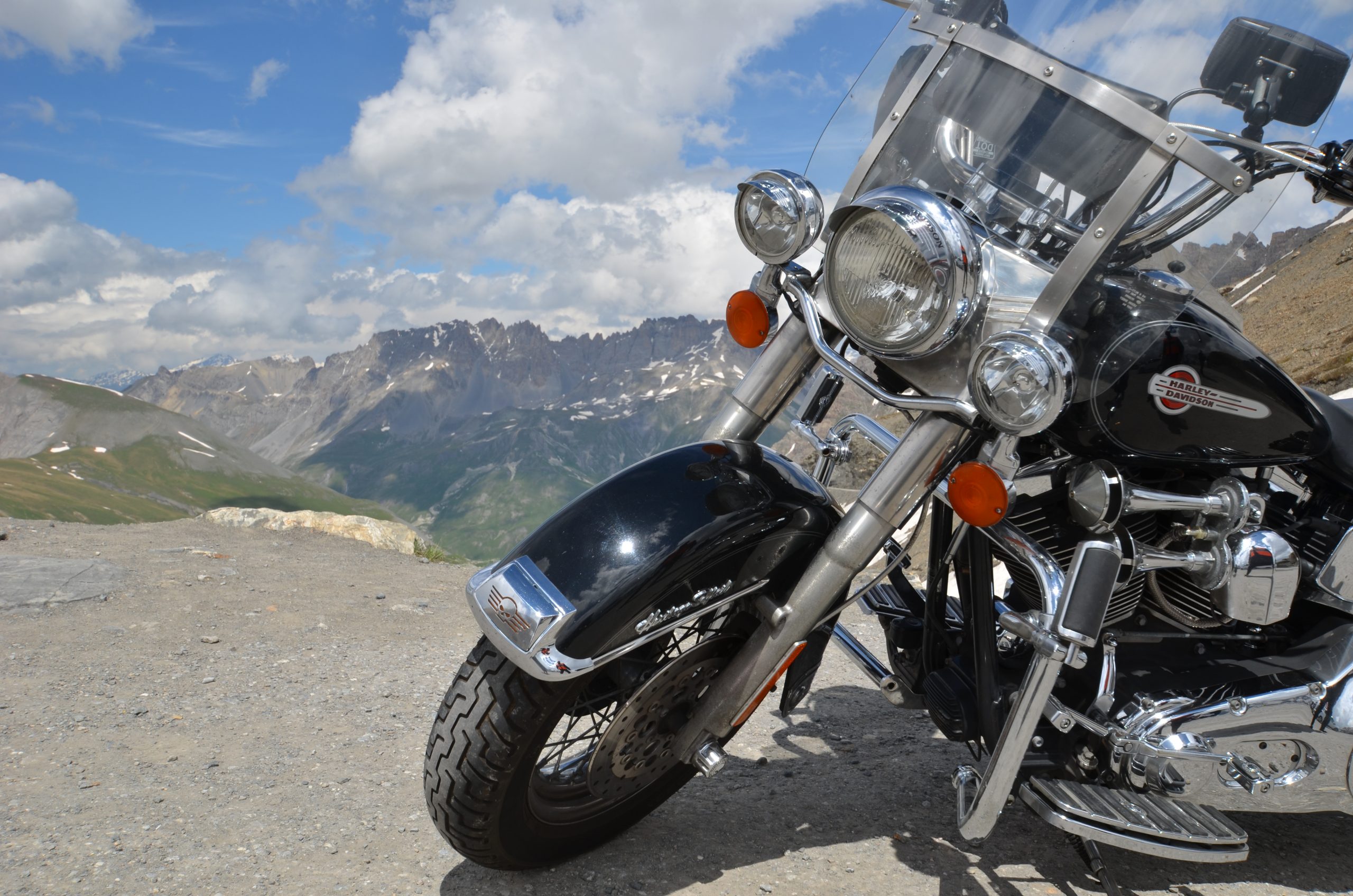 Motorbike parked overlooking alpine mountains